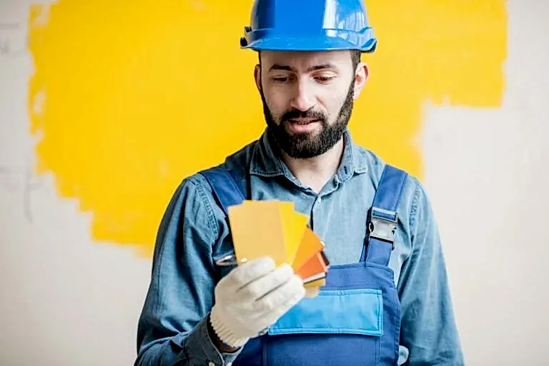 Painter with color swatches indoors